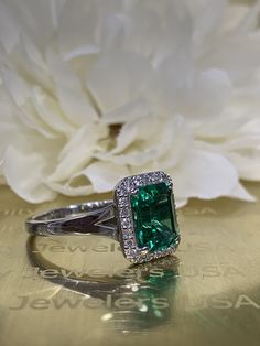 This ring is an emerald cut lab created green emerald with genuine diamond halo made with solid 14k white gold item #5457 We feature the finest quality lab grown emeralds in the world. The properties of lab-grown are physically, chemically and visually identical to natural, just grown in a lab setting. Emerald is the birthstone of May -Approximate total carat weight: 2.75ctw diamond equivalent -Center Stone Size: approx. 2.50ct diamond equivalent -Center Stone Shape: emerald cut 9x7mm -Gem Type: Classic Green Halo Ring With Diamond Accents, 14k White Gold Emerald Cut Halo Ring, Formal Emerald Ring With Halo Setting, Elegant Emerald Cut Emerald Ring With Halo Design, Elegant Emerald Cut Ring With Halo Design, Emerald Halo Ring For Formal Occasions, Classic Emerald Cut Halo Emerald Ring, Emerald Cut Emerald Ring With Halo, Formal Emerald Cut Emerald Ring With Halo