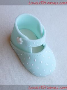 a pair of baby blue shoes sitting on top of a table