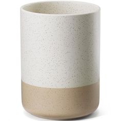 a white and tan vase with speckles on the outside, in front of a white background