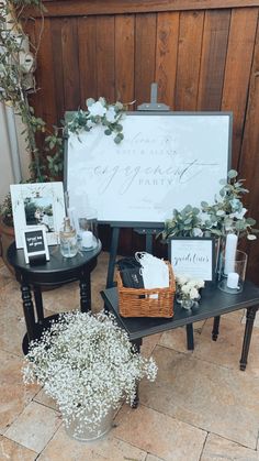 two tables with signs and flowers on them