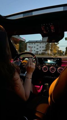 a woman sitting in the driver's seat of a car