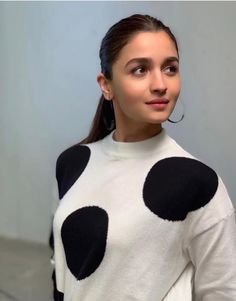 a woman with black and white polka dots on her sweater