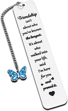 a bookmark with a blue butterfly on it and a chain attached to the book