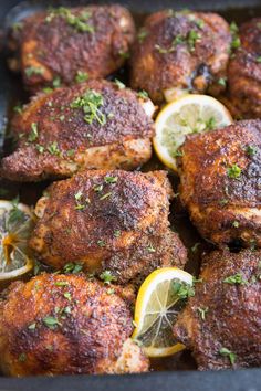 chicken thighs with lemons and herbs in a pan