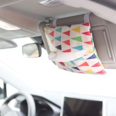 a colorful pillow hanging from the ceiling of a car