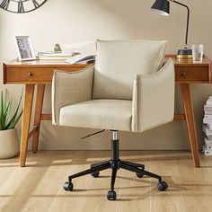 an office chair sitting in front of a desk with a clock on the wall behind it