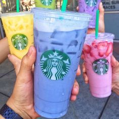 four different types of drinks in plastic cups with straws on the top and bottom