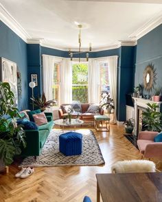 a living room with blue walls and wooden floors