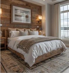 a large bed sitting in a bedroom next to a wooden headboard and window sill