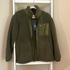 Brand New With Tags. Olive Green Sherpa Jacket With Faux Leather Trim And Chest Pocket. Size Medium. Khaki Fleece Outerwear For Fall, Khaki Outerwear With Fleece Lining For Fall, Cozy Green Outerwear With Pockets, Green Fleece Jacket For Winter, Cozy Khaki Outerwear With Pockets, Fleece Outerwear For Fall, Fleece Outerwear For Work In Fall, Fleece Outerwear For Fall Workwear, Green Fleece Outerwear For Winter