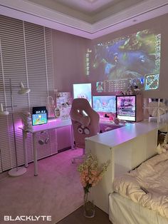 a bedroom with three computer monitors on the wall and a bed in front of it