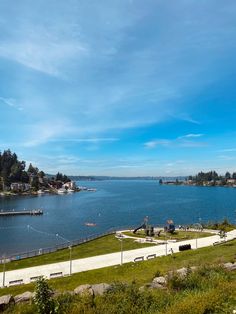 a view of the water from an overlook point on a sunny day with blue skies