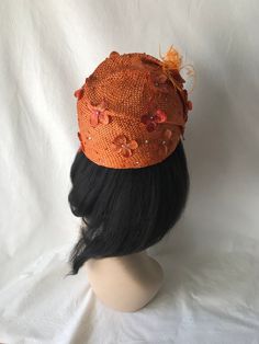 "This is a burnt orange Swarovski Crystal with flower pleated Formal hat for Women's Elegant designer COGIC church hat, Ladies Tea Party hat, wedding hat or any other special occasion. Fits 23.5\"-24\" Worn on both sides Pleated straw with hand curled ostrich feathers." Orange Fitted Headpiece For Kentucky Derby, Orange Short Brim Hat For Spring, Orange Headpiece For Kentucky Derby Races, Orange Headpieces For Kentucky Derby Races, Orange Mini Hat For Kentucky Derby Races, Orange Party Hat Headpiece, Orange Spring Evening Fascinator, Spring Evening Orange Fascinator, Orange Hat Fascinator For Races