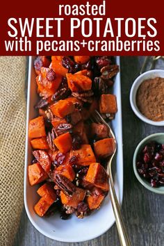 roasted sweet potatoes with pecans and cranberries in a white dish on a wooden table