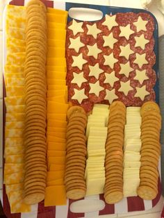 an american flag tray with crackers, cheese and sausages on it's sides