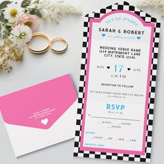 two wedding rings are sitting on top of a pink and black checkerboard save the date card