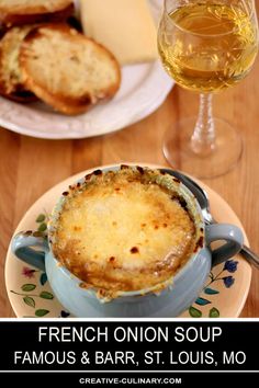 an image of a french onion soup on a plate with bread and wine in the background