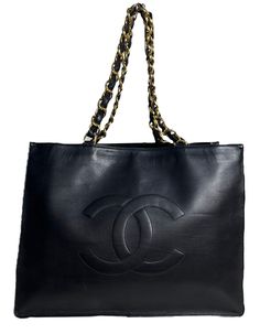 Chanel Vintage Black Leather CC Logo Tote Bag.  Features leather laced chain straps.  Made In: France Year of Production: 1994-1996 Color: Black Hardware: Goldtone Materials: Smooth lambskin leather Lining: Leather Closure/Opening: Open top  Interior Pockets: One zip Exterior Condition: Very good condition with some wear throughout Interior Condition: Very good  Measurements: 16"W 12"H x 4"D Handle Drop: 4" Strap Drop: 11" PLEASE NOTE: We will ship this item out fully insured, with signature required upon delivery.   A Second Chance is a family owned and operated luxury consignment and resale business located in NYC. We have been in business since 1993 and stand behind everything we sell with a 100% authenticity guarantee, or your money back. Selling only authentic pre-loved items has been Resale Business, Logo Tote Bag, Vintage Tote Bag, Chanel Vintage, Cc Logo, Second Chance, Black Hardware, Vintage Chanel, Open Top