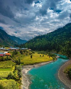 a river running through a lush green valley