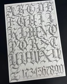 some type of lettering that looks like it has been drawn on the back of a paper