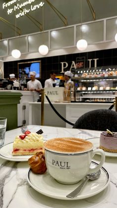 two plates with desserts on them sitting on a table in front of a counter