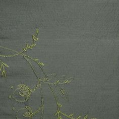 an embroidered piece of cloth with flowers on it