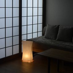 a living room filled with furniture and a lit lamp