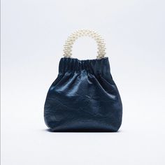 Style #: 6539 610 009 Crossbody Bag In Blue, Wrinkled Effect Exterior, Handle With Faux Pearls, Crossbody Chain Shoulder Straps, Lined Interior, And Magnetic Closure Made With 100% Polyurethane Thermoplastic (Strap), 95% Polyester/5% Polyurethane Fibre (Main Material), 100% Iron (Shoulder Strap), And 100% Polyester) Measurement: 7.5”X6.3”X3.1” New With Tag Storage: Bg - 1999 - 01012020 Blue Zara Bags For Everyday Use, Zara Blue Bags For Everyday Use, Orange Purse, Crossbody Saddle Bag, Studded Bag, Zara Bags, Zara Leather, Women Crossbody Bag, Quilted Purses