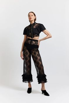 Details High-waisted cropped pants in sheer black lace with four layers of ruffles at the hem. Side zipper closure Worn with the Ashlyn Blouse Content + Care 100% Polyester Dry Clean Only Made in NYC Fit Fits true to size Birgitt is 5'11" and wears a size 2 Size 2 Measurements: Bust - 27" Waist - 41" Size 10 Measuremen Lace Pants Outfit, High Waisted Cropped Pants, Casual Academia, 2024 Wardrobe, Nyc Fits, Basic White Tee, Floral Print Pants, Lace Pants, Ruffle Pants