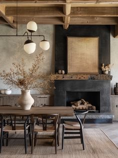 a dining room table with chairs and a fire place