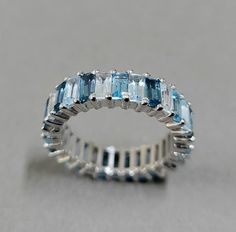 Features - 1. Baguette Multi Color Topaz Silver Band 2. Made to Order 3. Total weight - 3.450 Grams 4. Silver Purity - 925 5. Silver Weight - 2.530 Grams 6. Stone Weight - Sky Blue Topaz - 1.2 Carat White Topaz - 1.05 Carat London Blue Topaz - 1.05 Carat Swiss Blue Topaz - 1.2 Carat 7. Weight Of Topaz Baguette Each Pieces - 0.15 Carat. 8. Baguette Topaz Size - 2x4 mm 9. No Of Topaz Pieces - 30 Pieces 10. Band Width - 5 mm 11. Setting - Prong 12. Ready to dispatch in 3 days. 13. Cut - Baguette 14 Blue Topaz Baguette Cut Ring, Baguette Cut Blue Topaz Ring, Faceted Ring, Baguette Ring, Everyday Rings, Sky Blue Topaz, Rings Cool, Topaz Stone, Swiss Blue Topaz