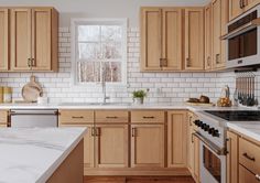 a kitchen with wooden cabinets and white marble counter tops, along with stainless steel appliances