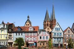 a row of colorful houses in front of a church