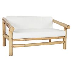 a wooden bench with white cushions on it