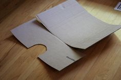 two pieces of cardboard sitting on top of a wooden floor