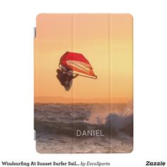 an ipad case with a photo of a person parasailing in the ocean at sunset