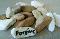 some rocks that have the word forgive written on them