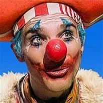 a clown wearing a red nose and hat