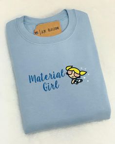 "IN \"PERSONALIZATION\" TELL US WHICH POWERPUFF GIRL YOU WANT ! ORDERS OVER $80 SHIP FREE WITH CODE : FREESHIP80 **If ordering local to Belleville, NJ - please message us directly for FREE shipping info on all orders** Custom orders only ( NOT PERSONALIZATION ) do not qualify for discounts or coupons . Message us if you have any questions for custom orders! \"Material girl \" Limited stock now available for sale! ⁃Available in T-shirts & Crewnecks ⁃Unisex sizes ⁃Machine embroidered T-shirt: Comf Customizable Cute Cotton Sweatshirt, Powerpuff Girl, Puff Girl, Material Girl, Embroidered Sweatshirt, Embroidered Tshirt, Material Girls, Embroidered Sweatshirts, Limited Stock