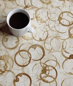 a cup of coffee sitting on top of a table