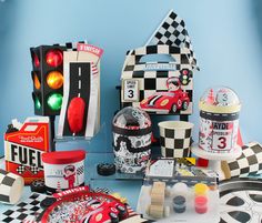 various items are displayed on a table in front of a blue wall with a checkered design