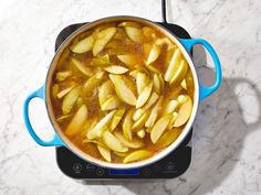 a pot filled with food sitting on top of a stove