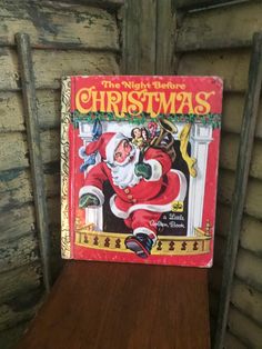 the night before christmas book sitting on top of a wooden shelf