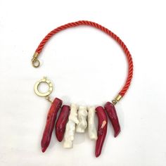 The beauty of silk red cord with red and white coral. A unique combination of materials that looks natural and fancy simultaneously.  A combination of fancy colors with natural stones.  The necklace is minimalist, lightweight, and elegant.  Vibrant ribbon color with natural stones.  The necklace is 16 inches long and weighs 4 ounces. Hand-strung Red Coral Jewelry In Coral Color, Hand-strung Red Coral Jewelry, Red Coral Hand-strung Necklace, Unique Hand-strung Red Coral Necklaces, Red Coral Necklace With Natural Stones, Unique Single Strand Red Beaded Necklace, Unique Red Single Strand Beaded Necklace, Adjustable Hand-strung Red Coral Necklace, Coral Necklace With Natural Red Coral Stones