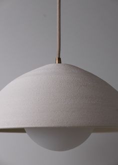 a white light hanging from a ceiling fixture