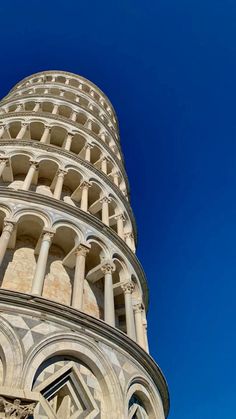 a tall tower with many windows on it's side and blue sky in the background