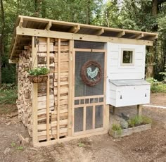 a chicken coop built into the side of a wooded area with a door and window