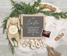 a baby announcement surrounded by items such as a teddy bear, t - shirt and tassels