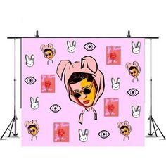 a pink backdrop with an image of a woman wearing sunglasses and bunny ears on it