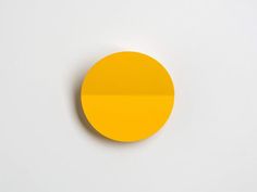 a round yellow object on a white surface